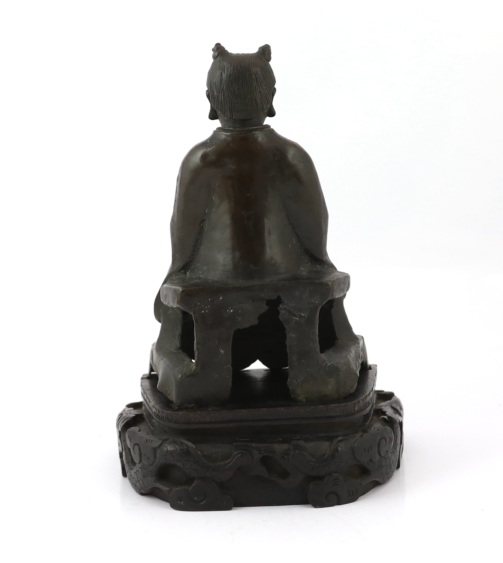 A Chinese bronze figure of a Daoist deity, late Ming, losses to back of throne